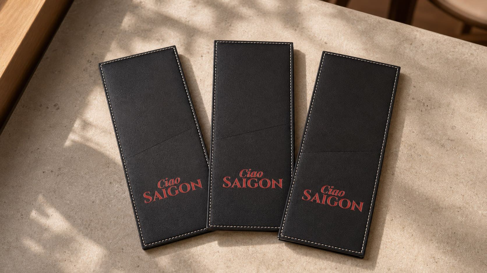 Black PU leather cutlery sleeves printed with a restaurant logo